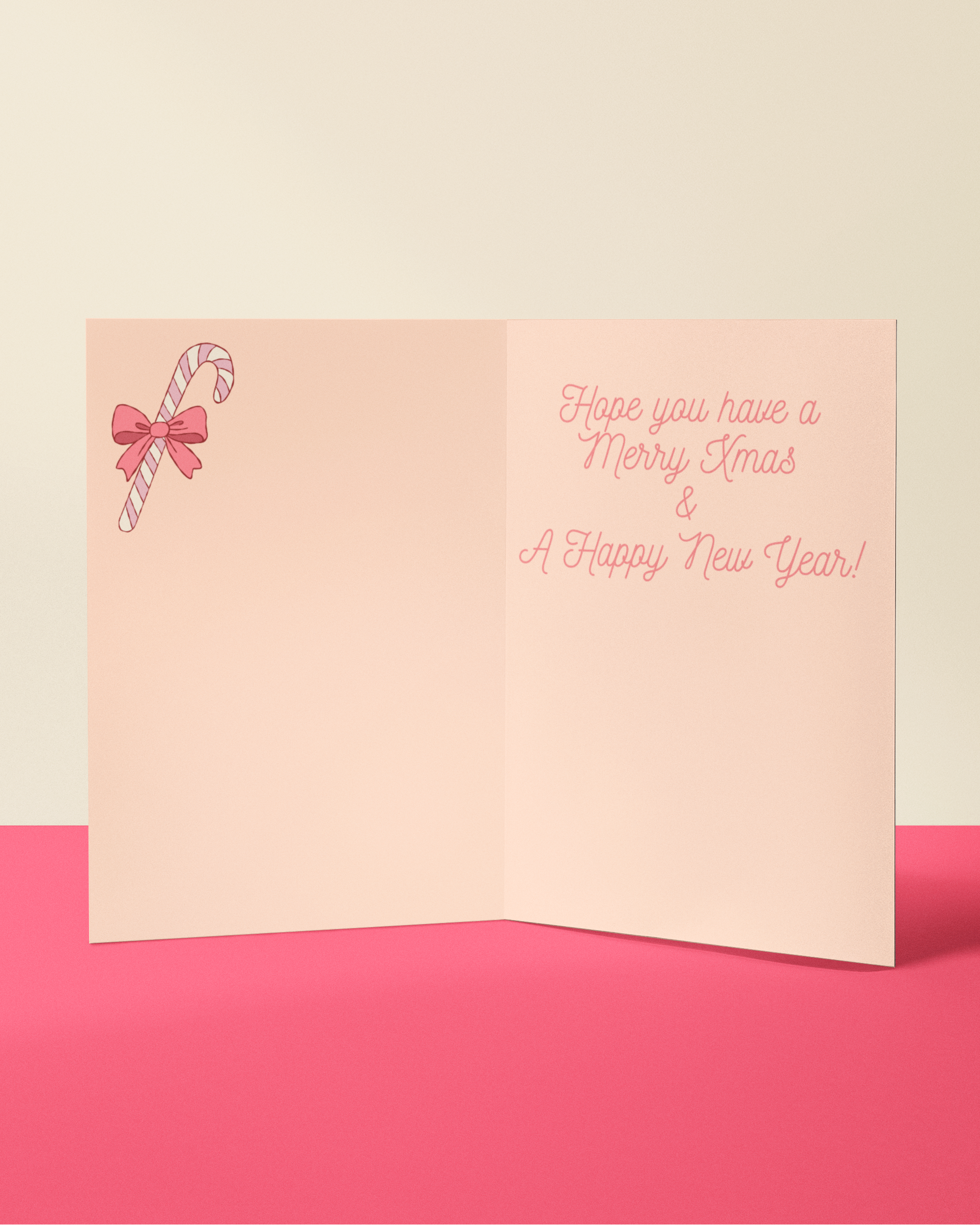 Pink greeting card with candy cane and bow design on a pink background